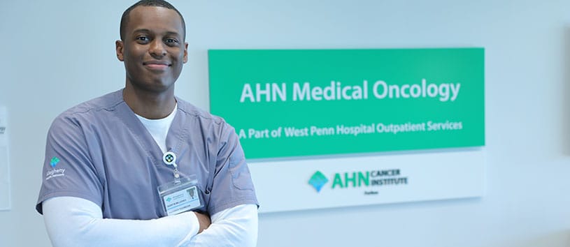 A health care professional smiles in a medical facility. 