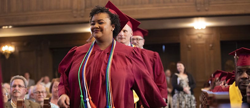 Bidwell Training Center graduates make their way down the aisle at their graduation ceremony.