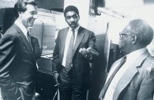 William E. Strickland, Jr. talking with two men in suits